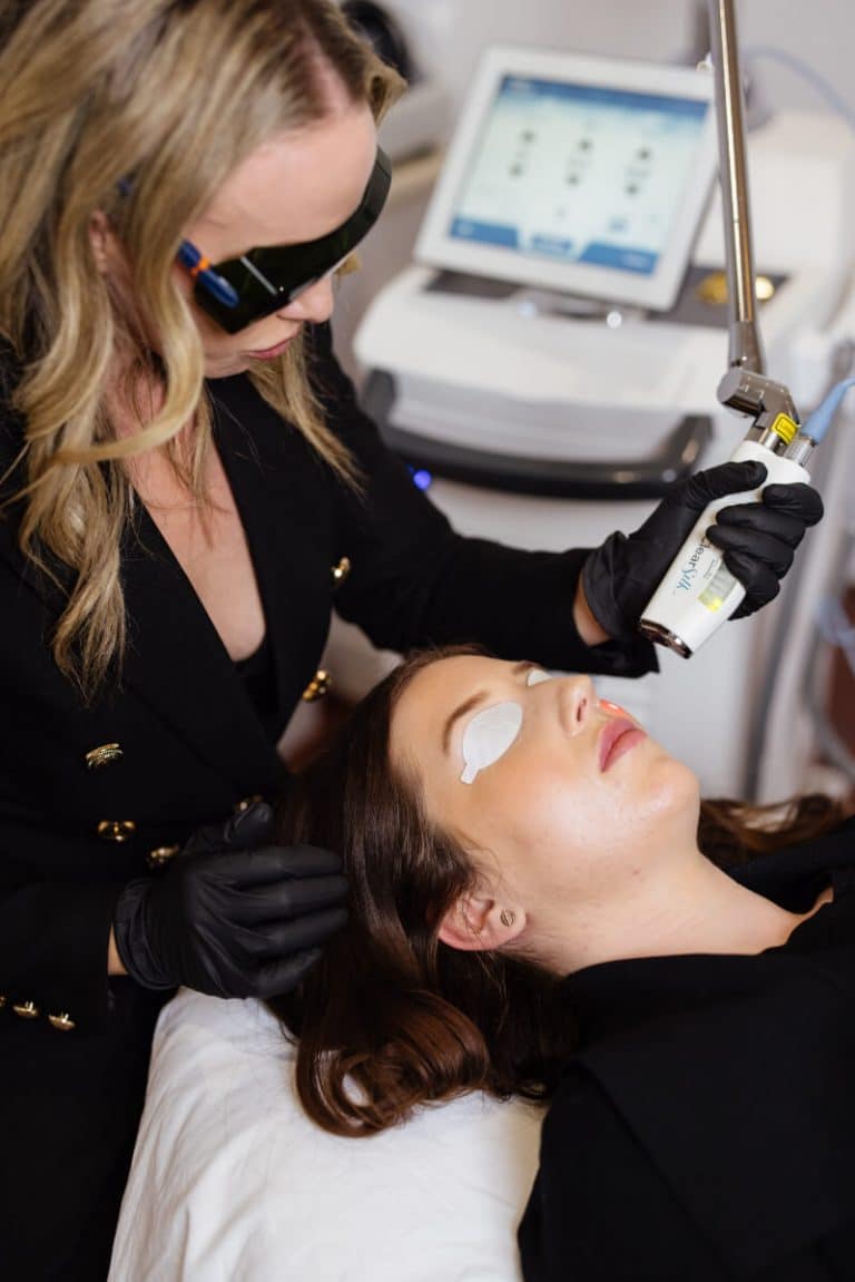 Dr Kate using ClearSilk laser on woman's face